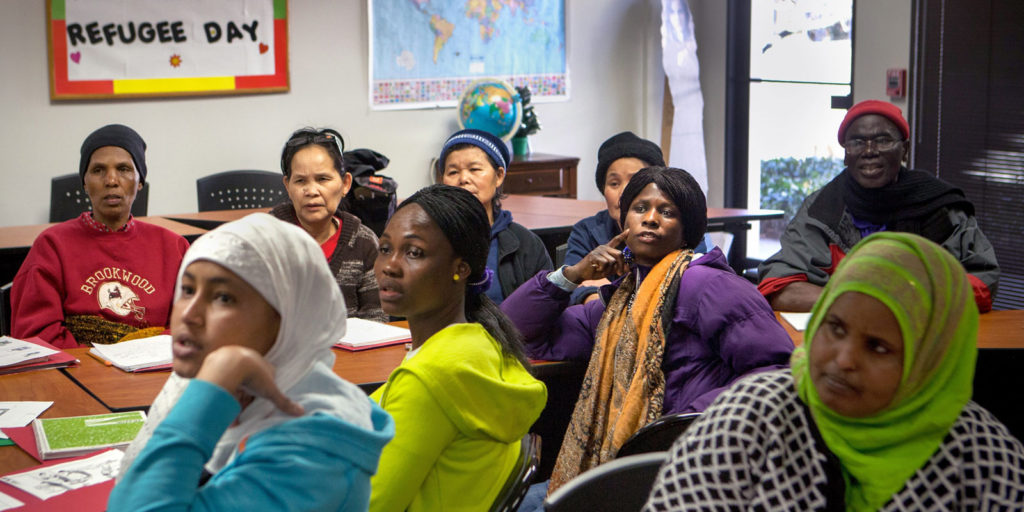 A group of refugees attending a cultural orientation class at their local resettlement office