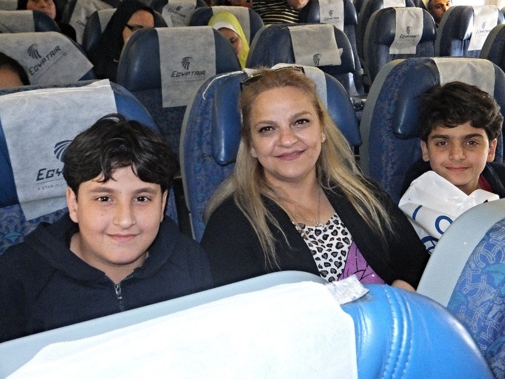 Mother with two sons on plane