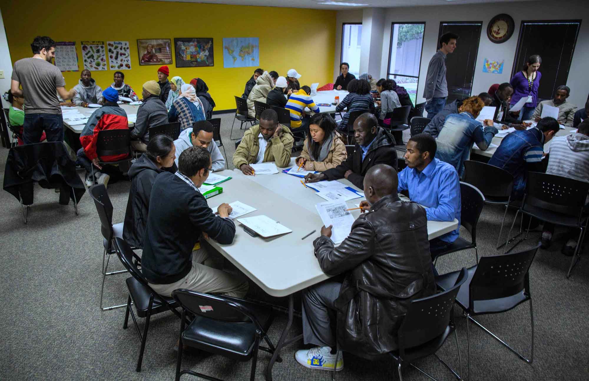 Resettled refugees learning English during a cultural orientation class