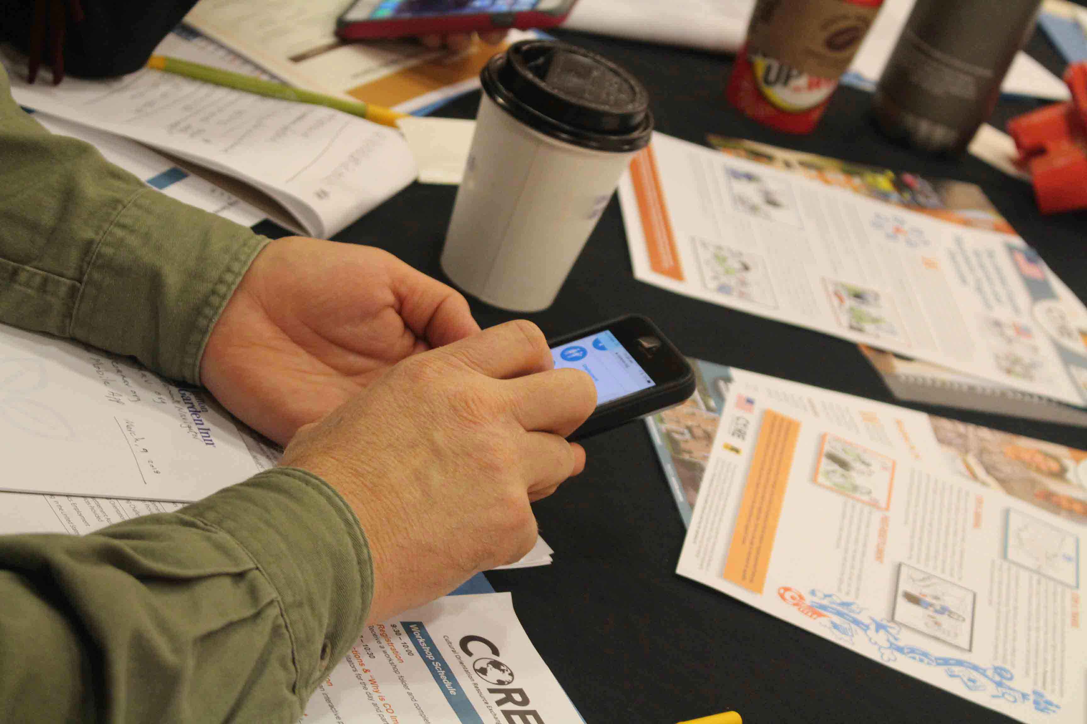 A person using CORE's COREnav resettlement navigator on their mobile phone