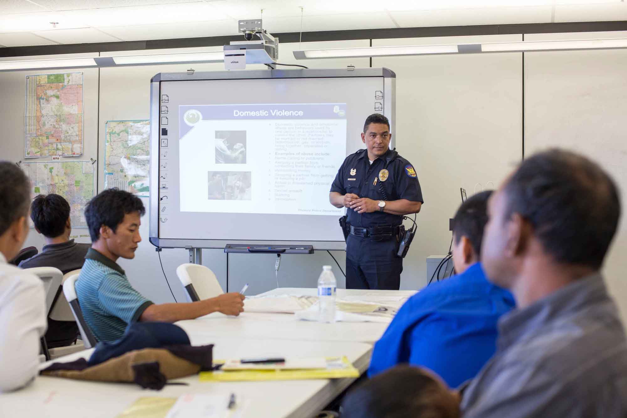 A police officer presenting to a class of newly resettled refugees