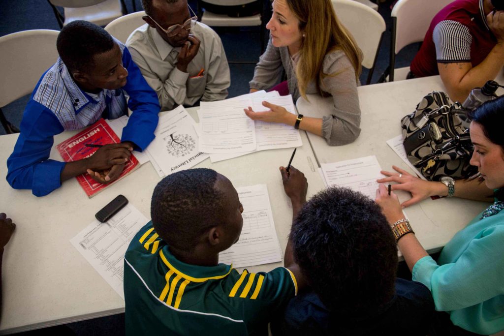 A group of refugees attending an ESL class at their local resettlement office