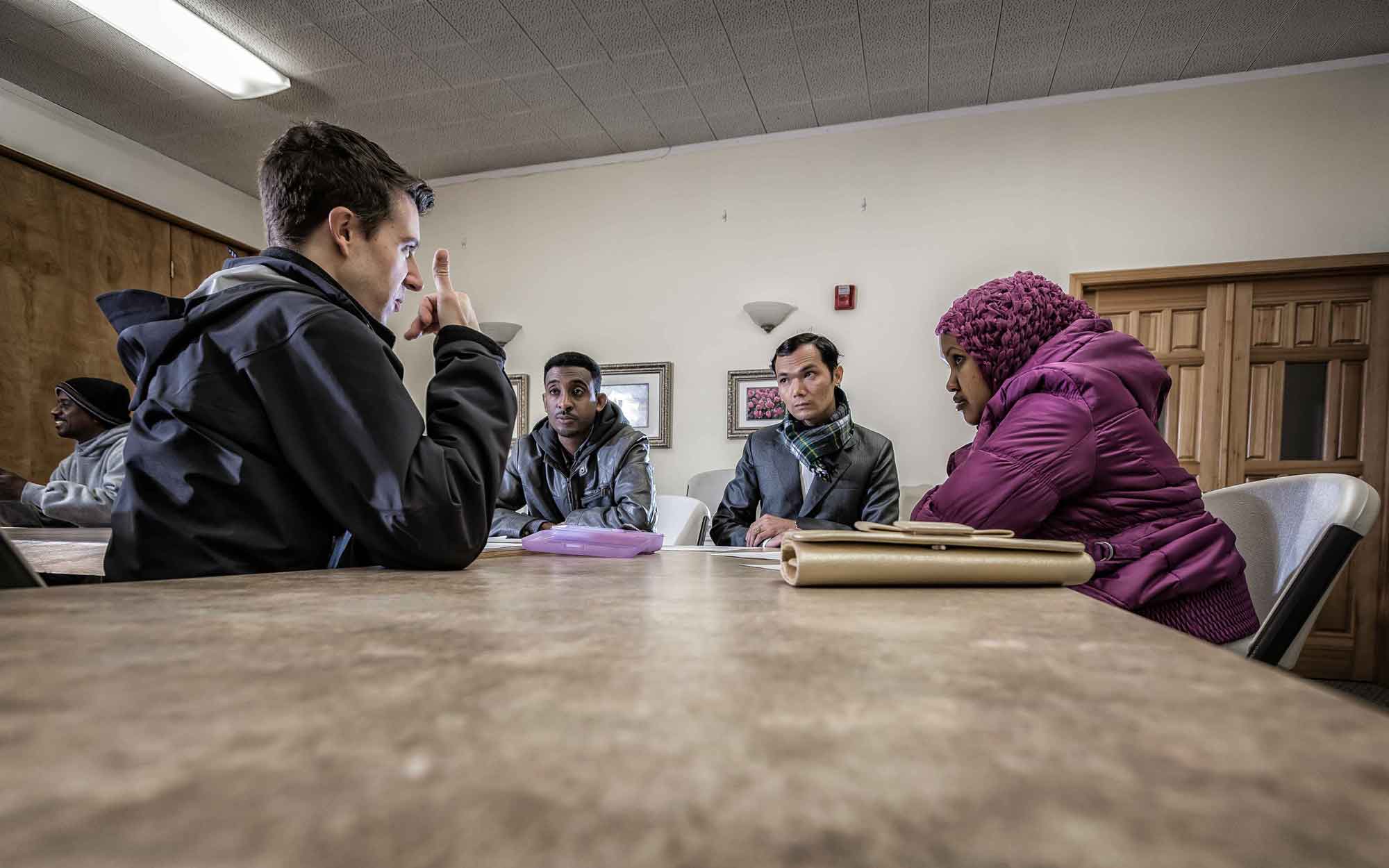 Refugees attending a cultural orientation class and learning about U.S. employment