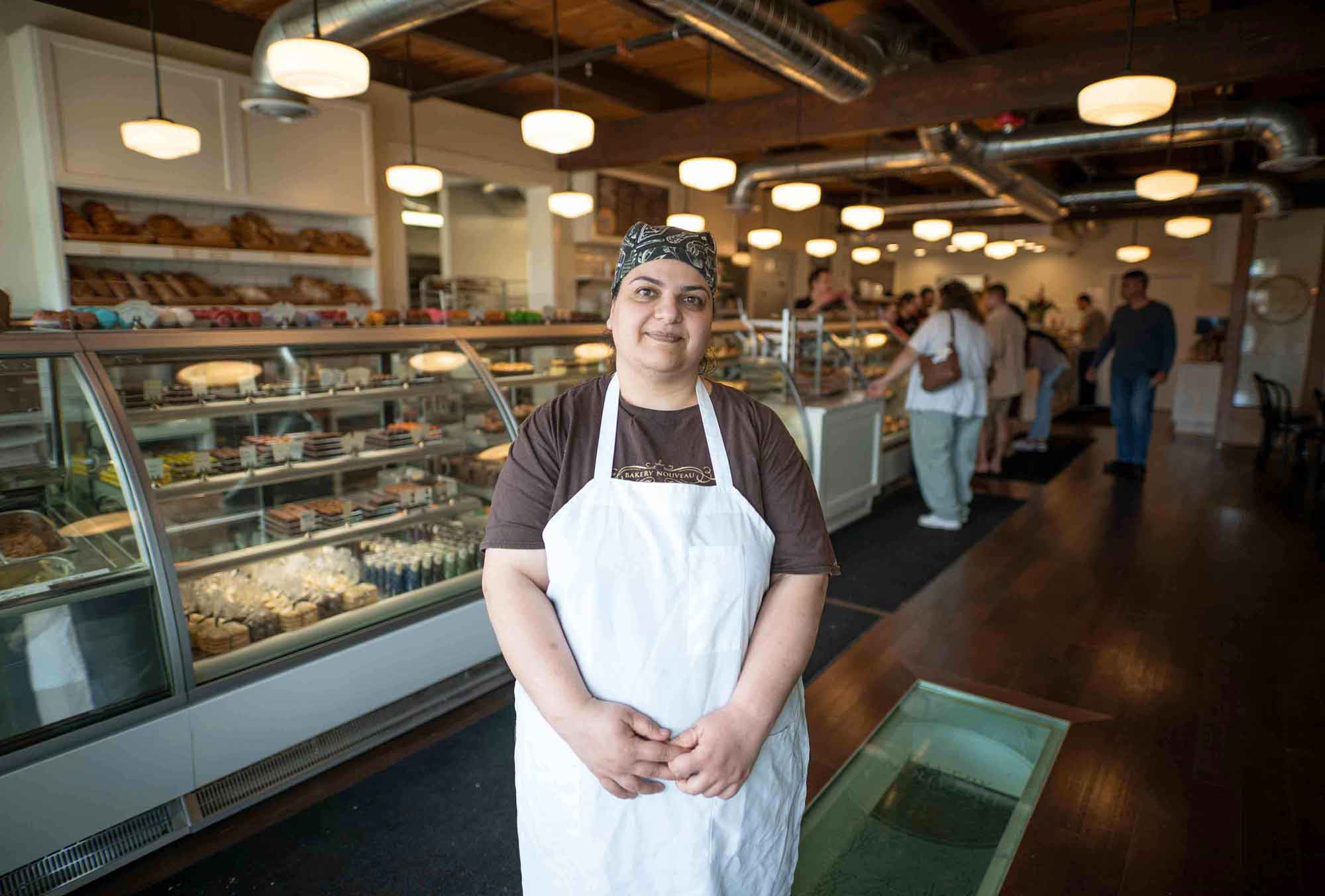 A recently resettled refugee at her job in a bakery