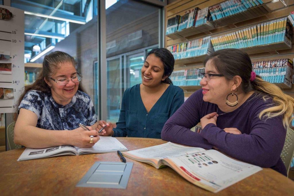 Two resettled refugees attending an English class at their local library