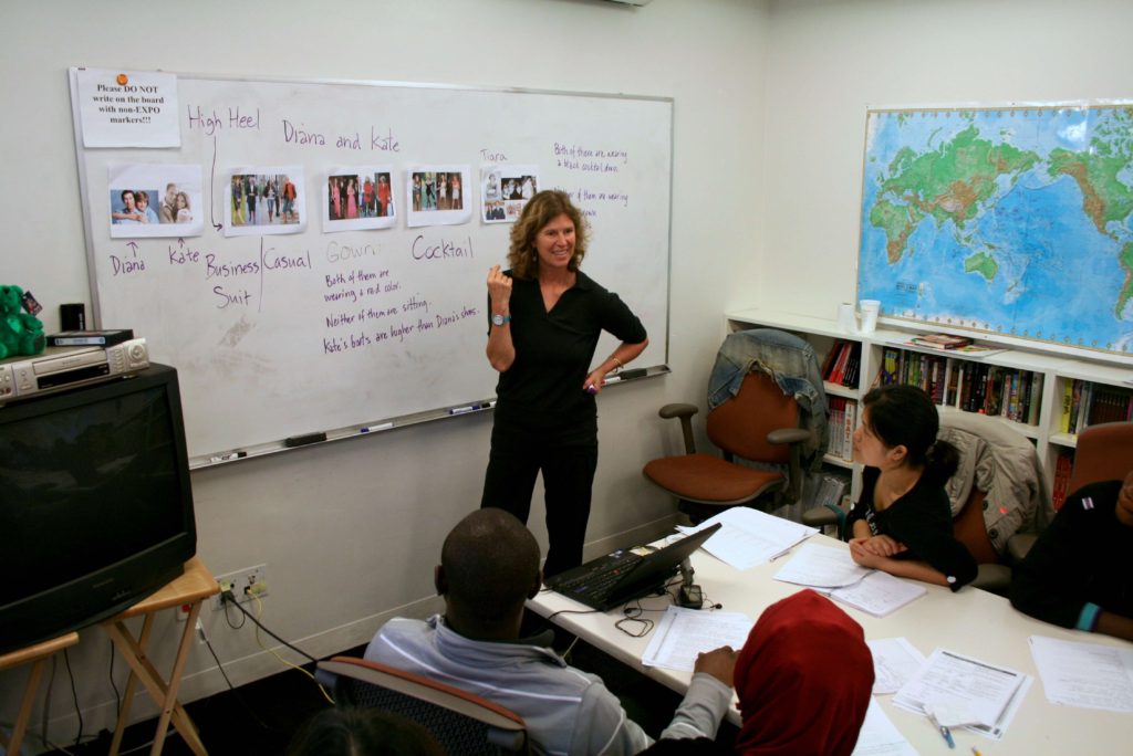 A Cultural Orientation provider teaching refugees about different attire for business, formal, and casual environments in the United States