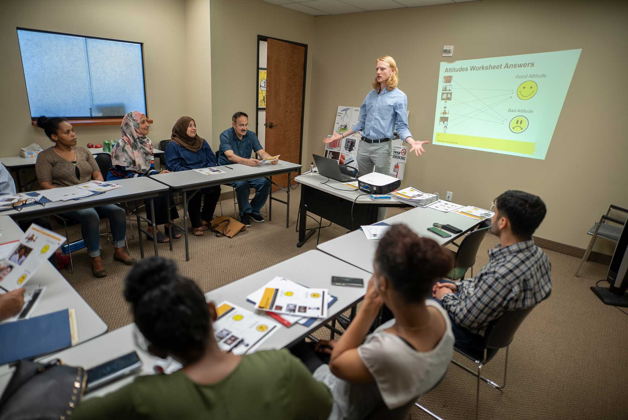 A cultural orientation provider teaching a class of refugees. IRC/AOberstadt