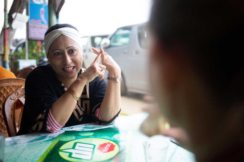 A refugee resettlement staff member talking with a client. IRC/NHowrose