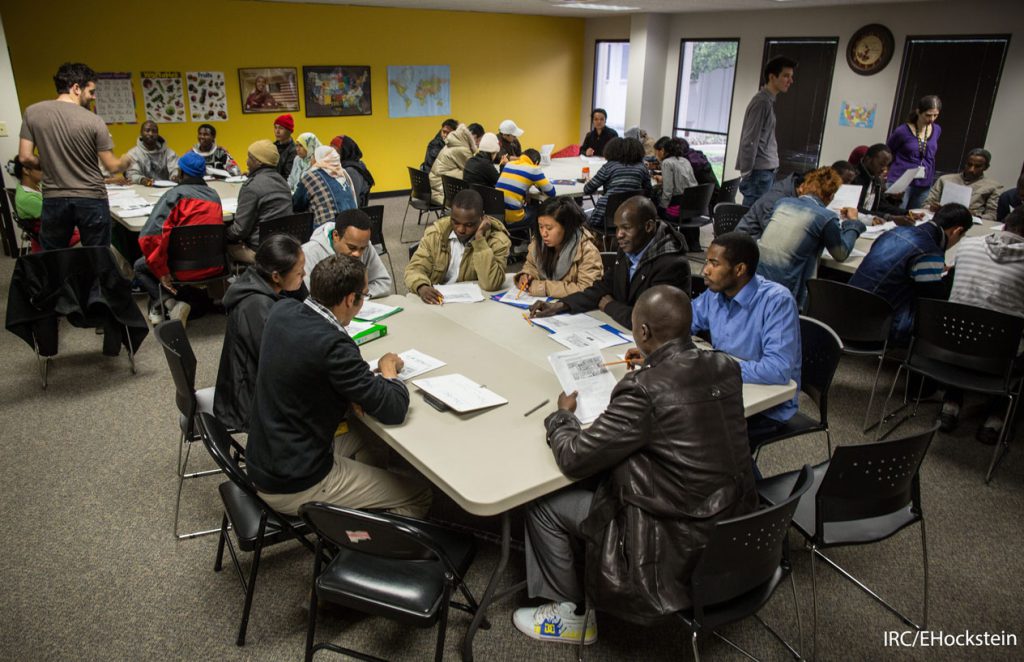 Resettled refugees learning English during a cultural orientation class. IRC/EHockstein